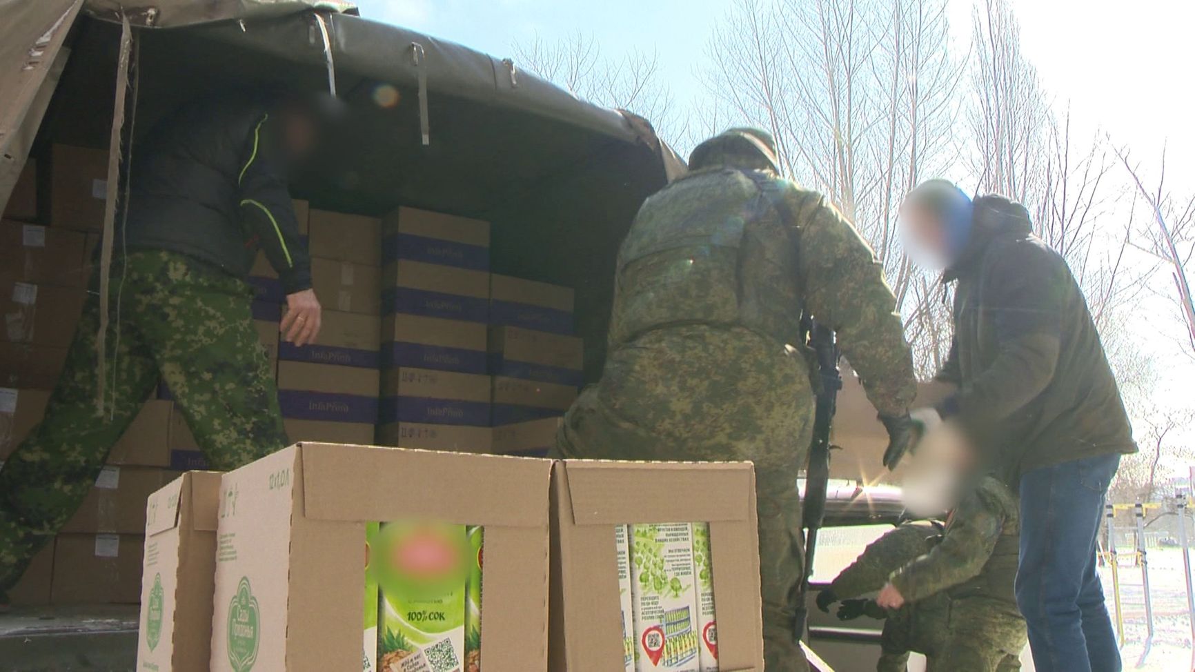 Russian soldiers receive a shipment of humanitarian aid