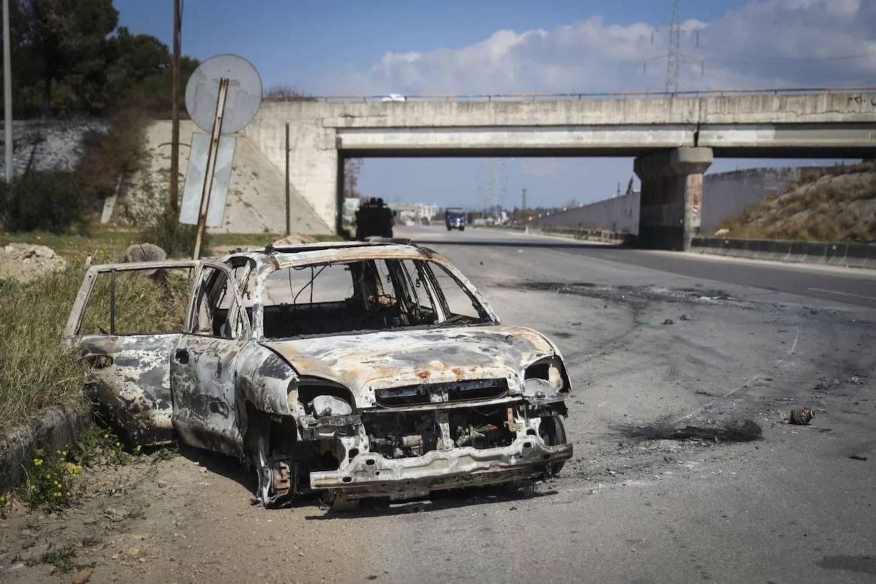 A car burned during clashes in Latakia