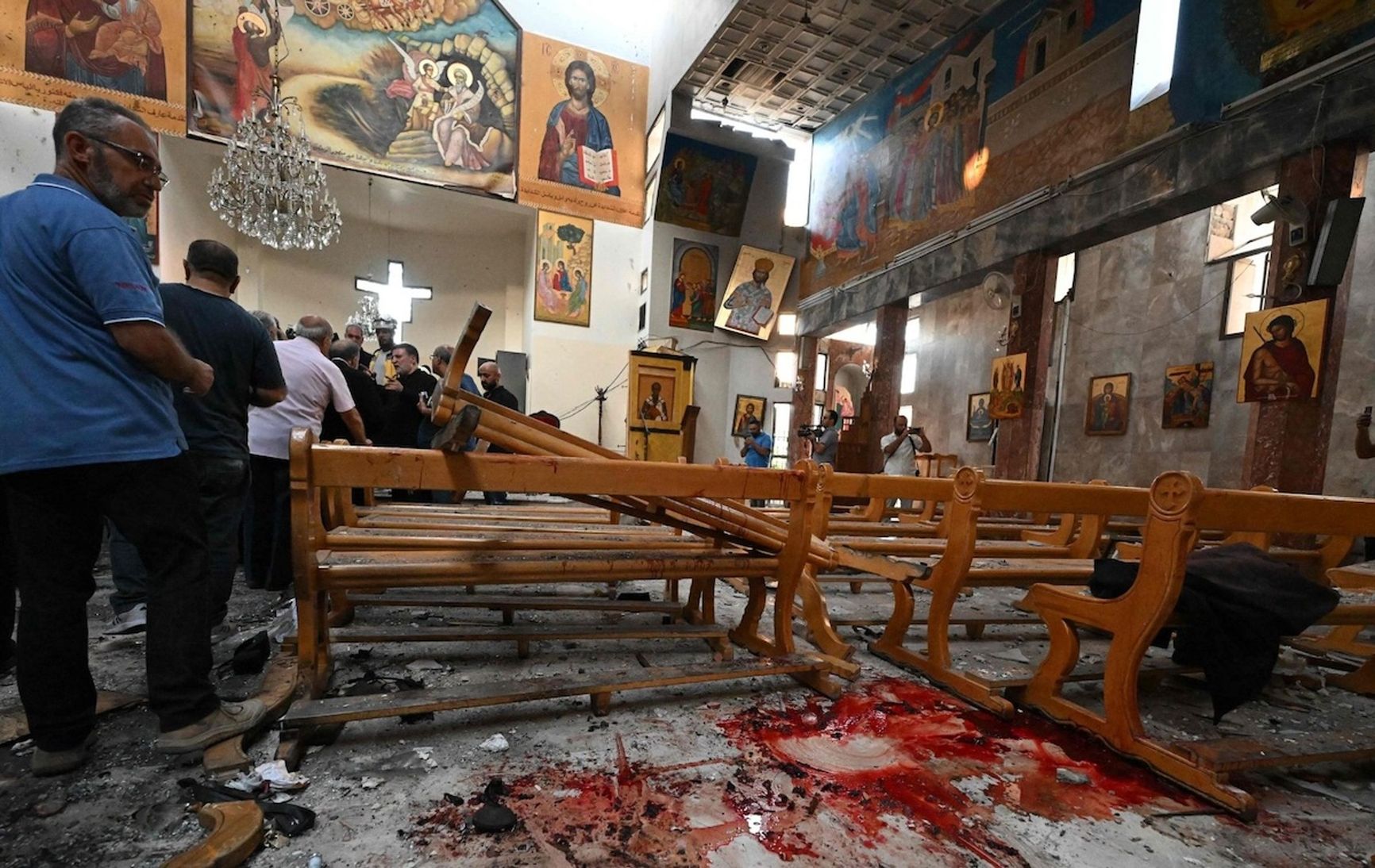A churchgoer looks at the aftermath of a bombing at Mar Elias Church.
